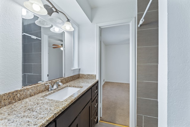 bathroom with a ceiling fan, vanity, and walk in shower