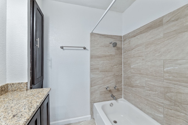 bathroom with vanity, baseboards, and bathing tub / shower combination