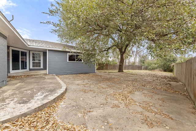 view of yard featuring a patio area and a fenced backyard