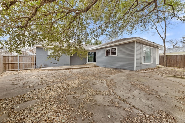 back of property featuring fence and a patio