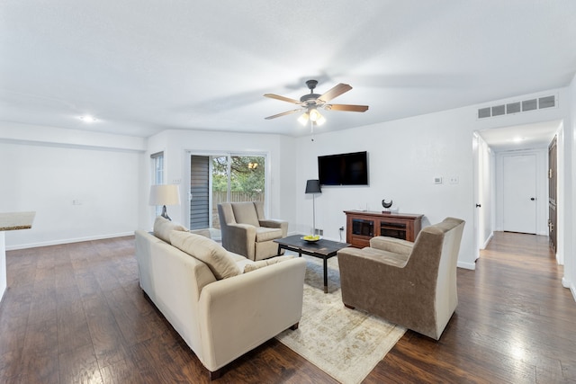 living area featuring ceiling fan, dark wood-type flooring, visible vents, and baseboards