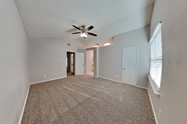 unfurnished bedroom featuring baseboards, visible vents, lofted ceiling, a textured ceiling, and carpet floors