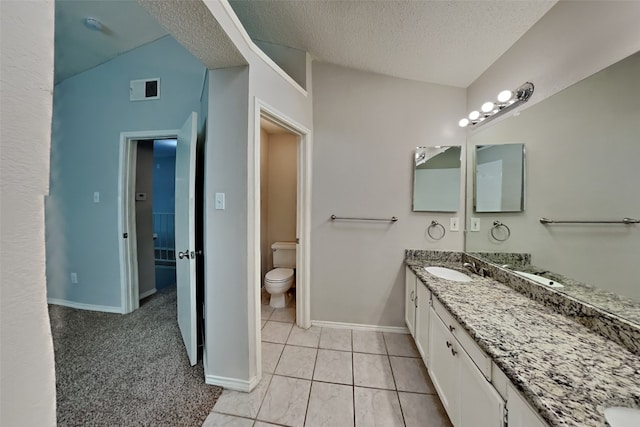 full bath featuring visible vents, toilet, a textured ceiling, vanity, and baseboards