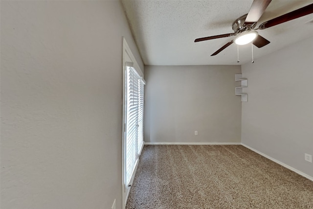 carpeted spare room with a textured ceiling, ceiling fan, and baseboards