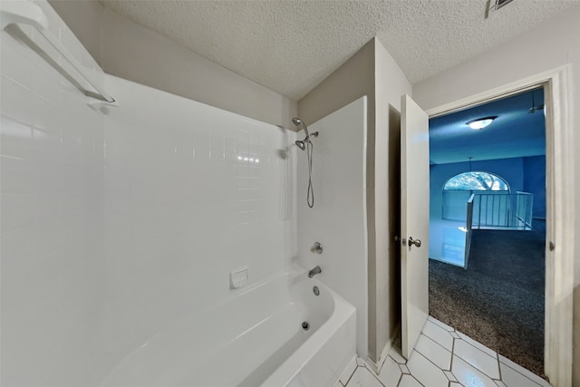 full bath with tile patterned flooring, shower / bath combination, and a textured ceiling