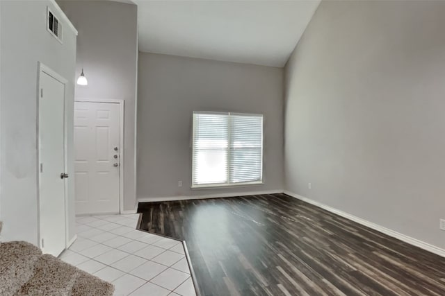 interior space featuring light wood-style flooring, visible vents, and baseboards