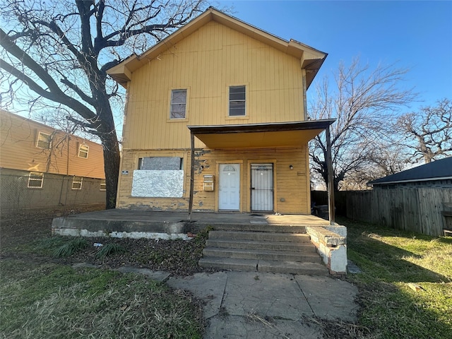 view of front facade with a fenced backyard and a porch