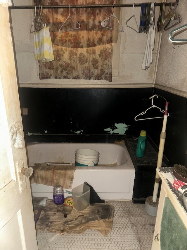 full bathroom with a bathtub and tile patterned floors