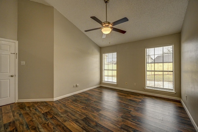 empty room with baseboards, dark wood-style floors, ceiling fan, vaulted ceiling, and a textured ceiling