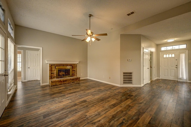 unfurnished living room featuring baseboards, a fireplace, visible vents, and dark wood-type flooring