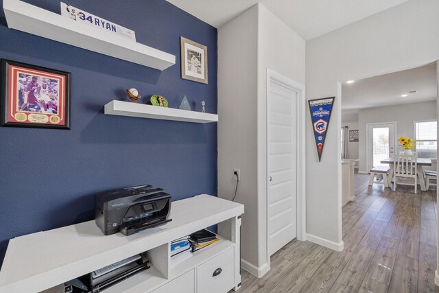 office with light wood-style flooring and baseboards