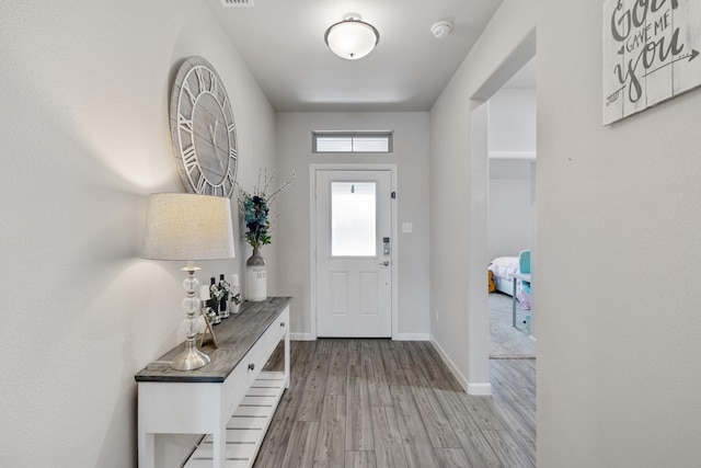 entryway featuring light wood finished floors and baseboards