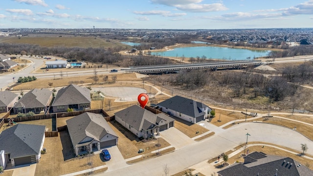 birds eye view of property with a water view and a residential view