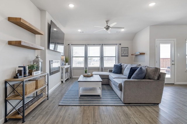 living area featuring recessed lighting, ceiling fan, baseboards, and wood finished floors