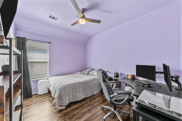 bedroom with lofted ceiling, a desk, wood finished floors, and a ceiling fan