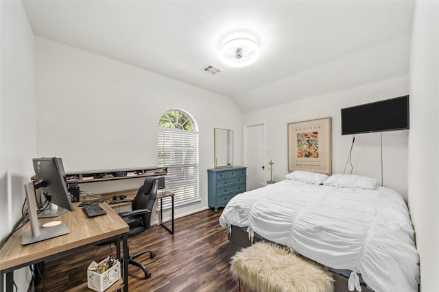 bedroom with dark wood finished floors, vaulted ceiling, an office area, and baseboards