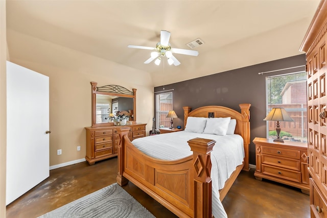 bedroom with finished concrete floors, baseboards, and a ceiling fan
