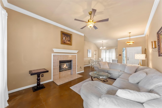 living room with ornamental molding, baseboards, a ceiling fan, finished concrete flooring, and a tile fireplace