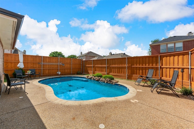 view of pool with a patio area and a fenced backyard