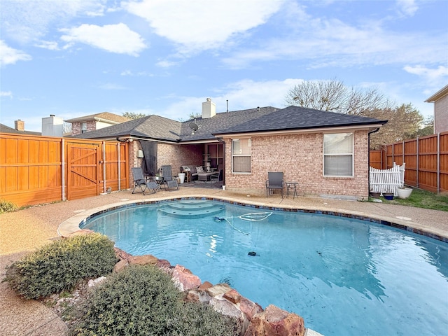 view of swimming pool with a fenced backyard, a gate, a fenced in pool, and a patio