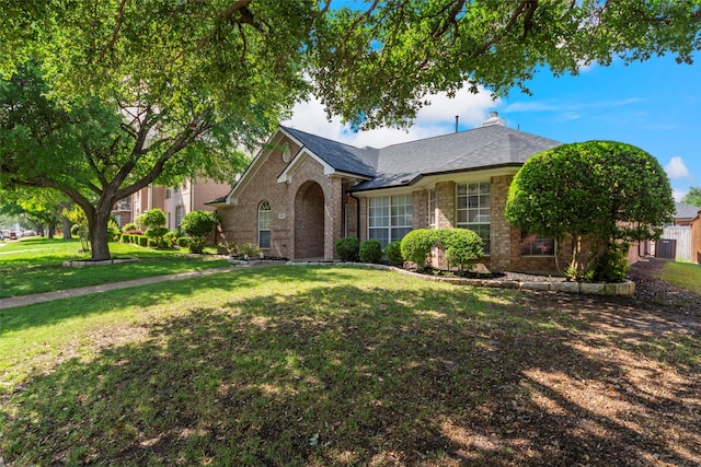 view of front of property featuring a front lawn and brick siding