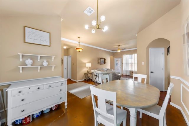 dining room with a ceiling fan, crown molding, and a chandelier