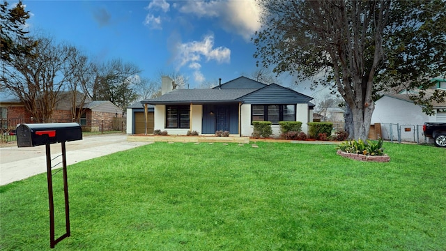 view of front of property featuring driveway, a chimney, an attached garage, fence, and a front yard