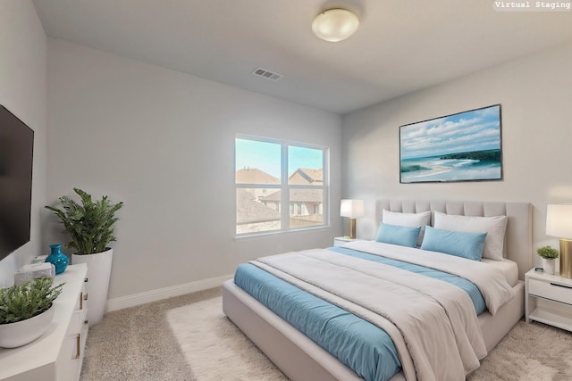 bedroom featuring visible vents, light carpet, and baseboards