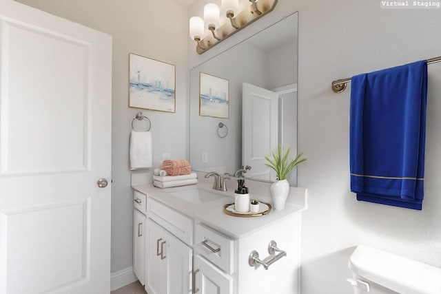 bathroom featuring toilet and vanity