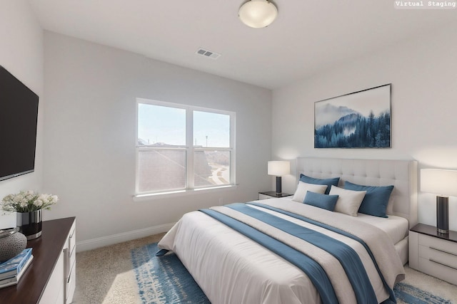 carpeted bedroom featuring visible vents and baseboards