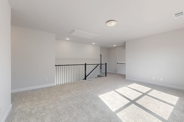 unfurnished room featuring light carpet, baseboards, visible vents, and recessed lighting