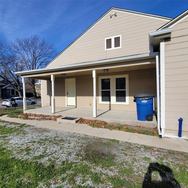 rear view of property with covered porch