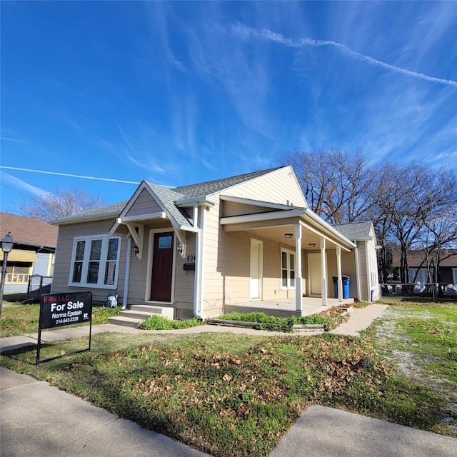 view of front of house with a porch and a shingled roof