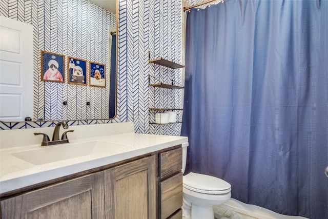 bathroom featuring toilet and vanity