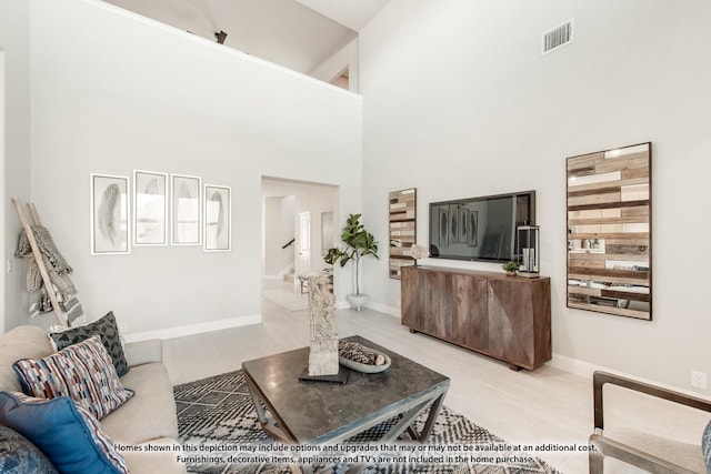 13133 Yellowstone Way, Providence Village, TX 76227 - living room with visible vents, a towering ceiling, baseboards, and wood finished floors