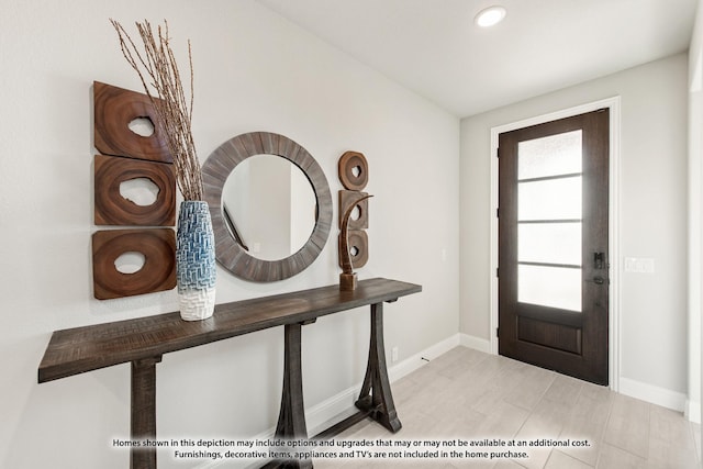 foyer featuring baseboards