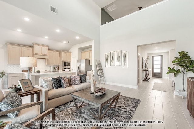 13133 Yellowstone Way, Providence Village, TX 76227 - living room featuring a towering ceiling, baseboards, visible vents, and recessed lighting