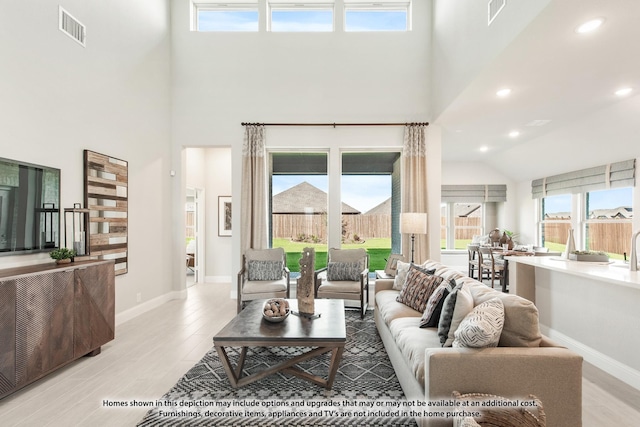 13133 Yellowstone Way, Providence Village, TX 76227 - living area with a towering ceiling, light wood finished floors, baseboards, and visible vents