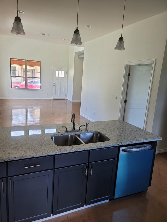 kitchen with light stone counters, a sink, open floor plan, hanging light fixtures, and stainless steel dishwasher