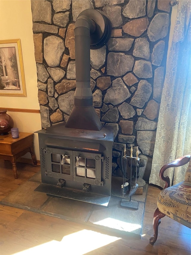 room details with a wood stove and wood finished floors