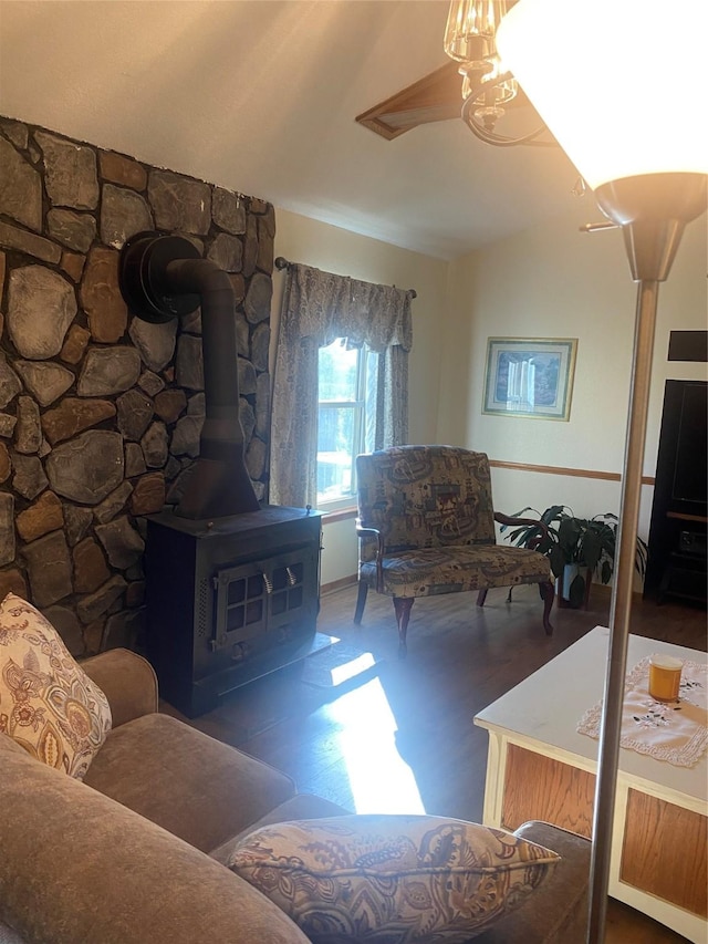 living room with a wood stove and lofted ceiling