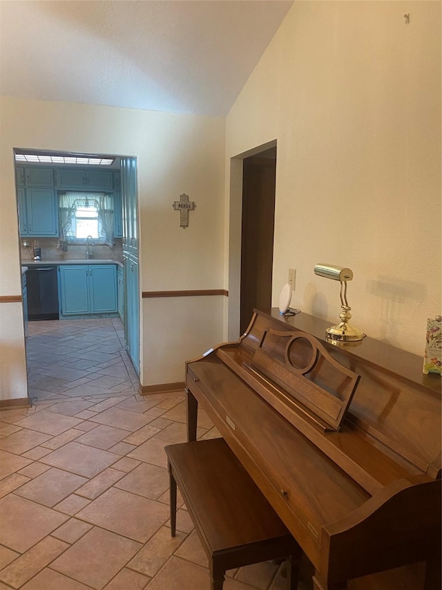 dining space with vaulted ceiling and baseboards