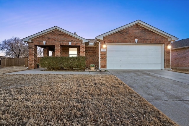 single story home with driveway, an attached garage, fence, and brick siding