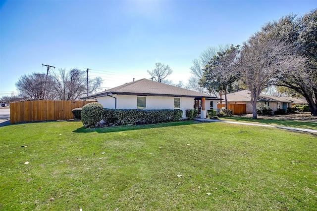 view of front of property with a front lawn and fence