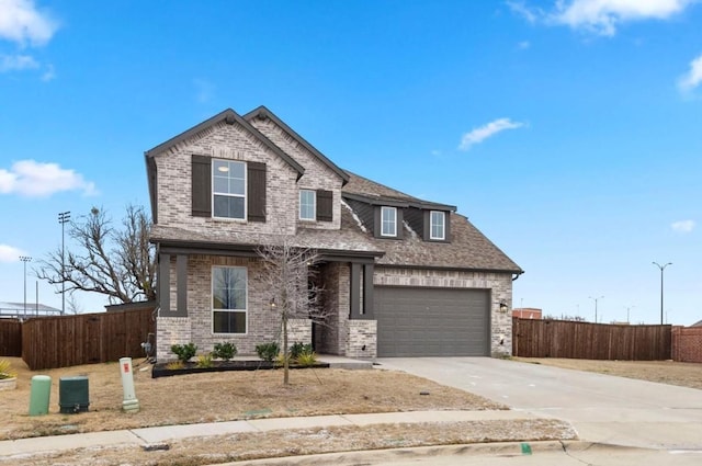 craftsman inspired home with a shingled roof, concrete driveway, brick siding, and fence