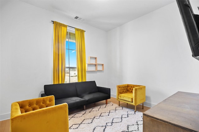 interior space with light wood-style flooring, visible vents, and baseboards