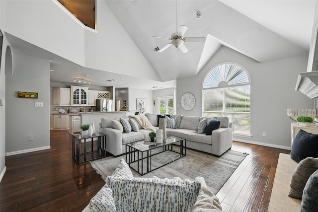 2781 Timber Crest Ln, Highland Village, TX 75077 - living room featuring dark wood-type flooring, ceiling fan, baseboards, arched walkways, and high vaulted ceiling