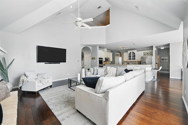 2781 Timber Crest Ln, Highland Village, TX 75077 - living area with arched walkways, a ceiling fan, dark wood-style floors, baseboards, and high vaulted ceiling