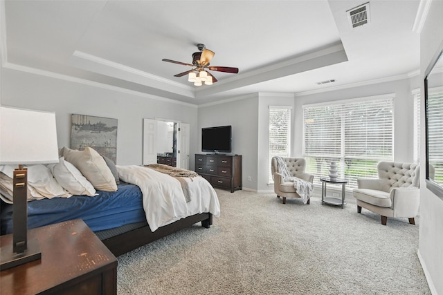 2781 Timber Crest Ln, Highland Village, TX 75077 - carpeted bedroom featuring a tray ceiling, multiple windows, ornamental molding, baseboards, and a ceiling fan