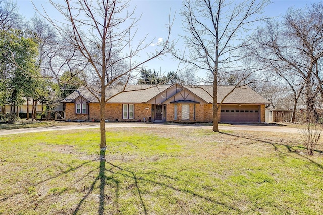 view of front facade featuring concrete driveway, a front lawn, an attached garage, and brick siding